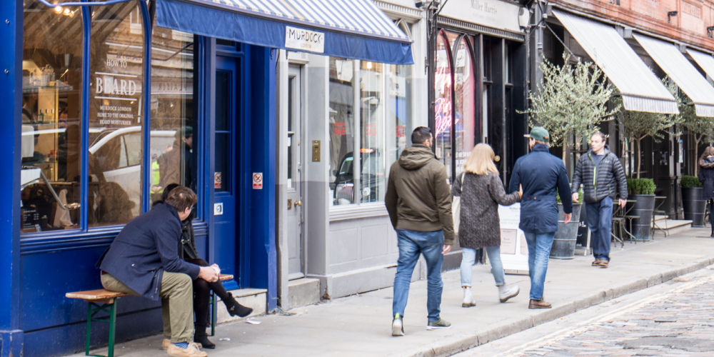 City street with shopfronts and pedestrians